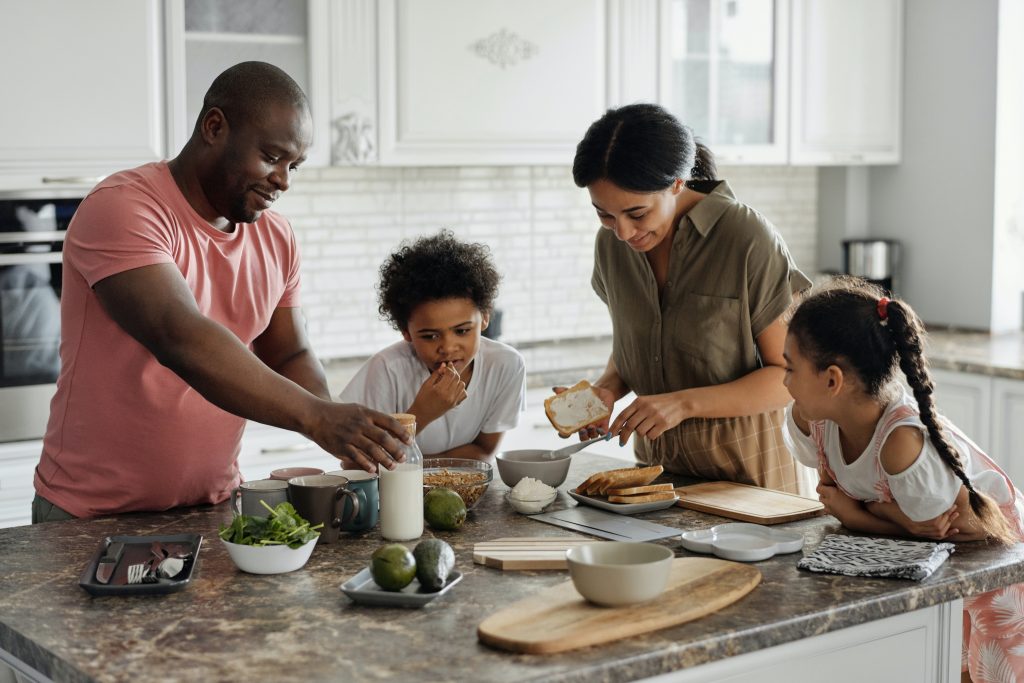 Family making lunch at a granite kitchen counter